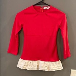 Red long sleeve shirt with white ruffles at bottom